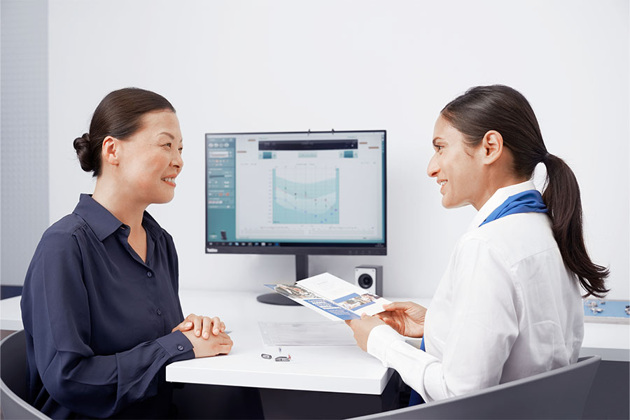 woman talking to her hearing instrument specialist