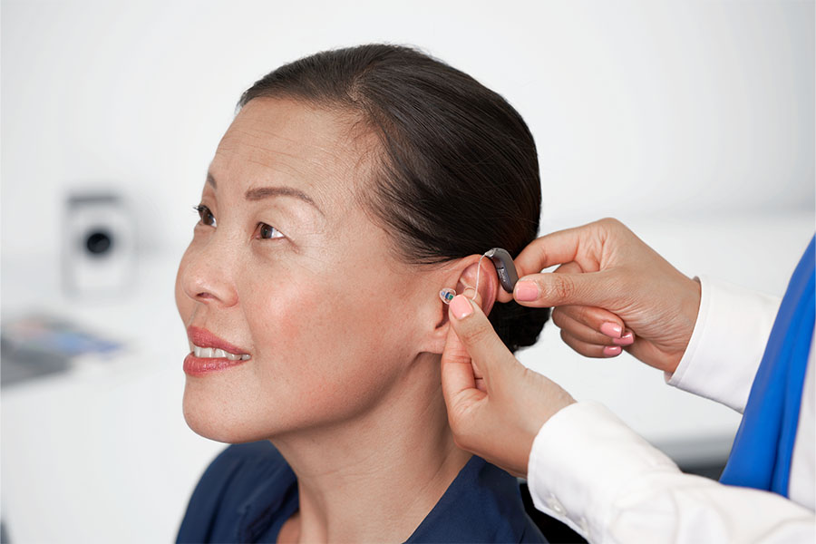 woman getting hearing aid